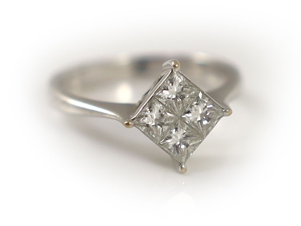 A modern 18k white gold and princess cut diamond set four stone cluster ring